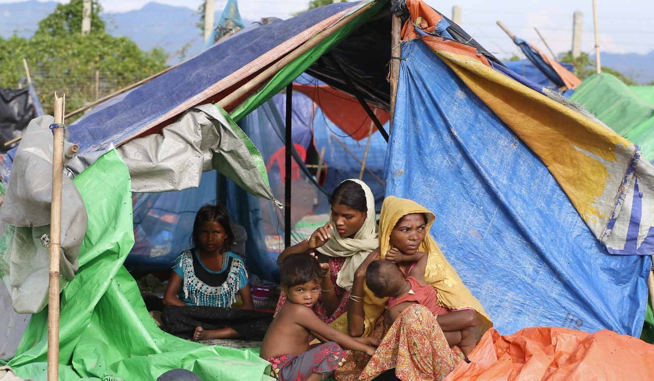 A Rohingya refugee child sits under a tent in a makeshift camp at the Myanmar-Bangladesh border. Photo: EPA