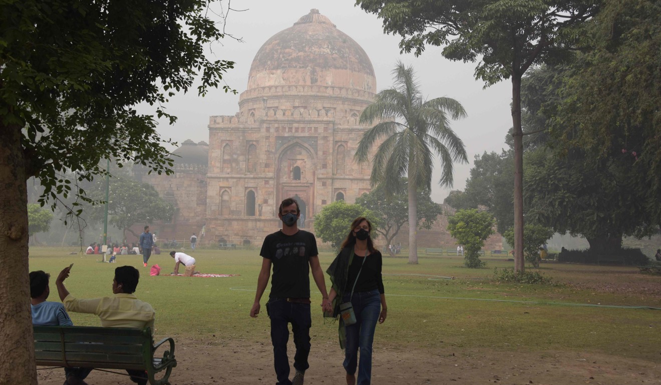 Tourists visiting Lodi Gardens amid heavy smog in New Delhi. Photo: AFP