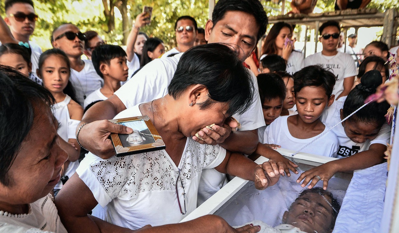 Relatives and friends mourn the death of 15-year-old Mark Lorenz Salonga, who according to relatives was a drug user and was shot dead by unidentified assailants on November 3. Photo: EPA