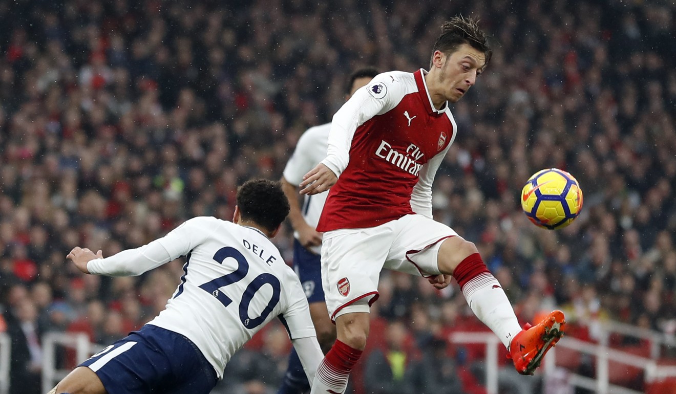 Arsenal's Mesut Ozil (right) is challenged by Tottenham's Dele Alli. Photo: AP