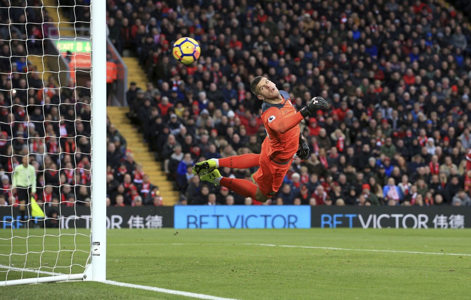 Southampton goalkeeper Fraser Forster dives as Salah swerves in the opener. Photo: AP