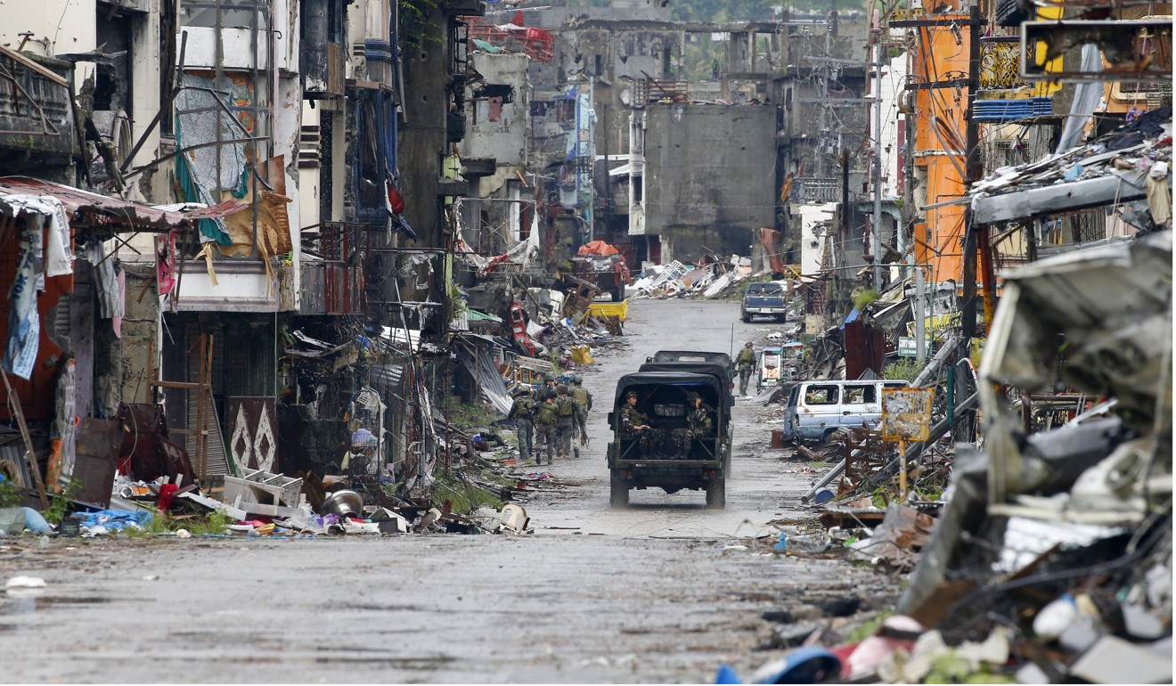 Troops patrol the decimated streets of Marawi. Photo: AP