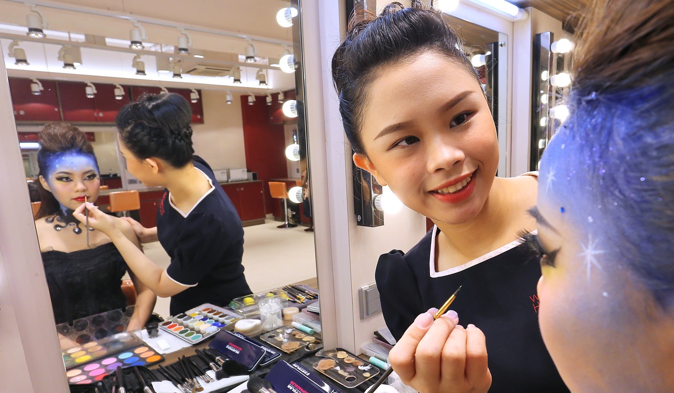 Beauty care diploma holder Lau Wai-yin does make-up for model Chan Yuk-ching. Photo: Dickson Lee
