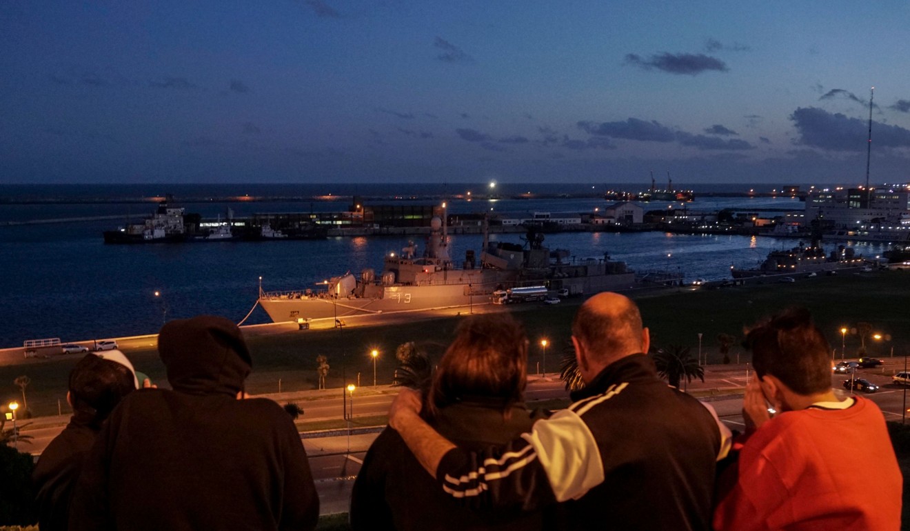 A family looks at Argentine Navy destroyer ARA Sarandi docked at Argentina's Navy base in Mar del Plata, on the Atlantic coast south of Buenos Aires, on November 20, 2017. Search vessels in the South Atlantic picked up noises on their sonar that they thought could be from a missing Argentine submarine, but those hopes have now been dashed. Photo: AFP