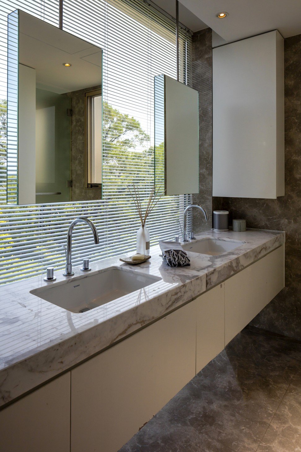 The master bathroom overlooks lush greenery.