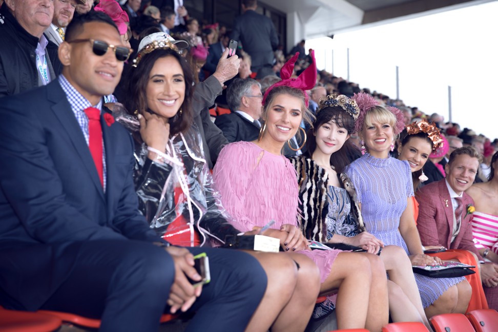 The Chinese actress (fourth right) sits with Australian celebrities at the Melbourne Cup.