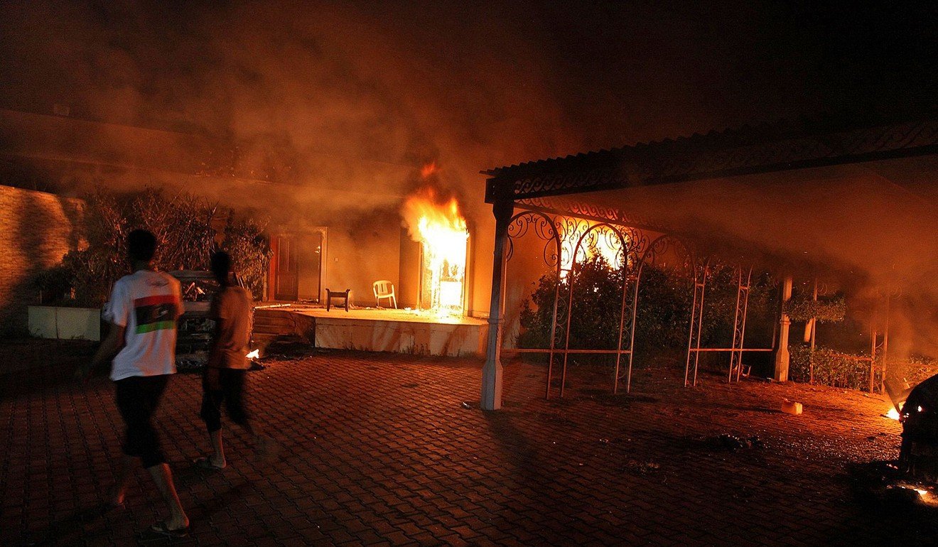 This file photo shows a vehicle and the surrounding buildings burning inside the US consulate compound in Benghazi late on September 11, 2012. Photo: Agence France-Presse