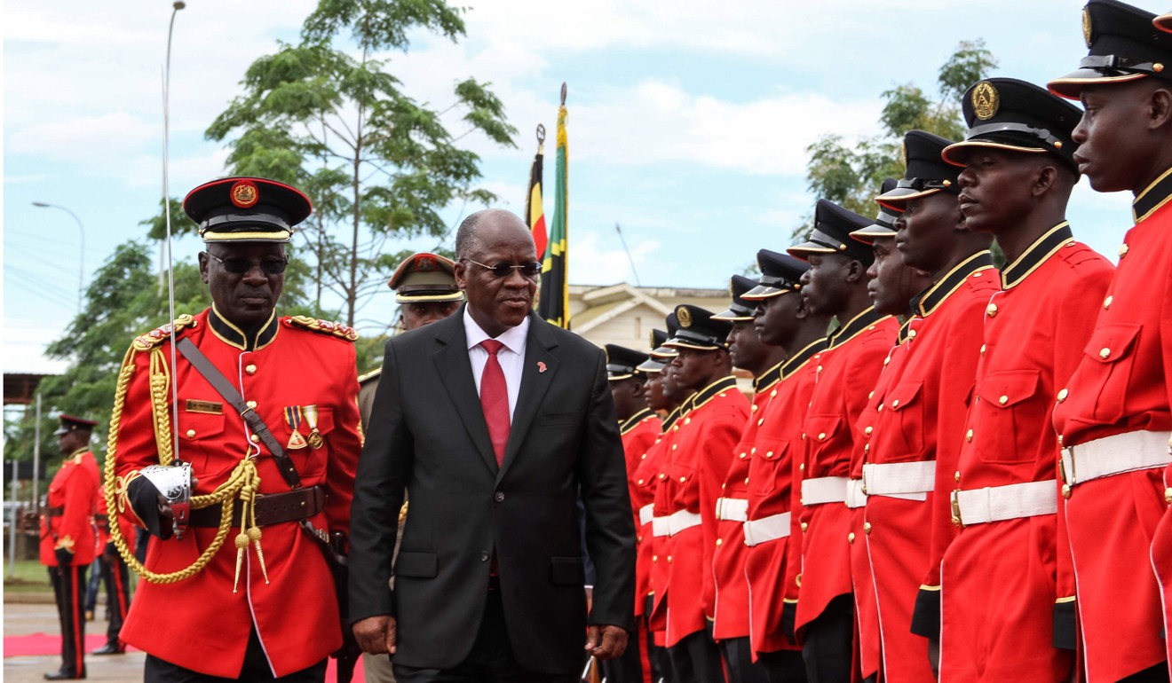 Tanzanian President John Magufuli reviews a military honour guard in Mutukula, Uganda, on November 9, before the ceremonial laying of a cross-border marker for the construction of an oil pipeline between the two countries. Photo: AFP
