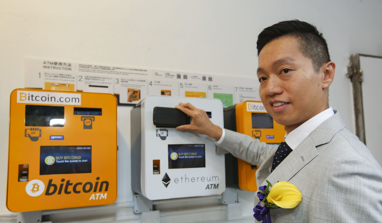 Hong Kong's renowned stock commentator, Agnes Wu shows the bitcoin ATM in Wan Chai. Photo: Edmond So