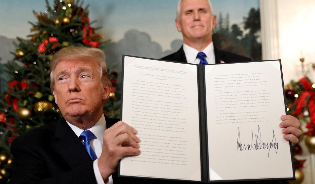US President Donald Trump holds up the proclamation he signed that the United States recognises Jerusalem as the capital of Israel and will move its embassy there. Photo: Reuters
