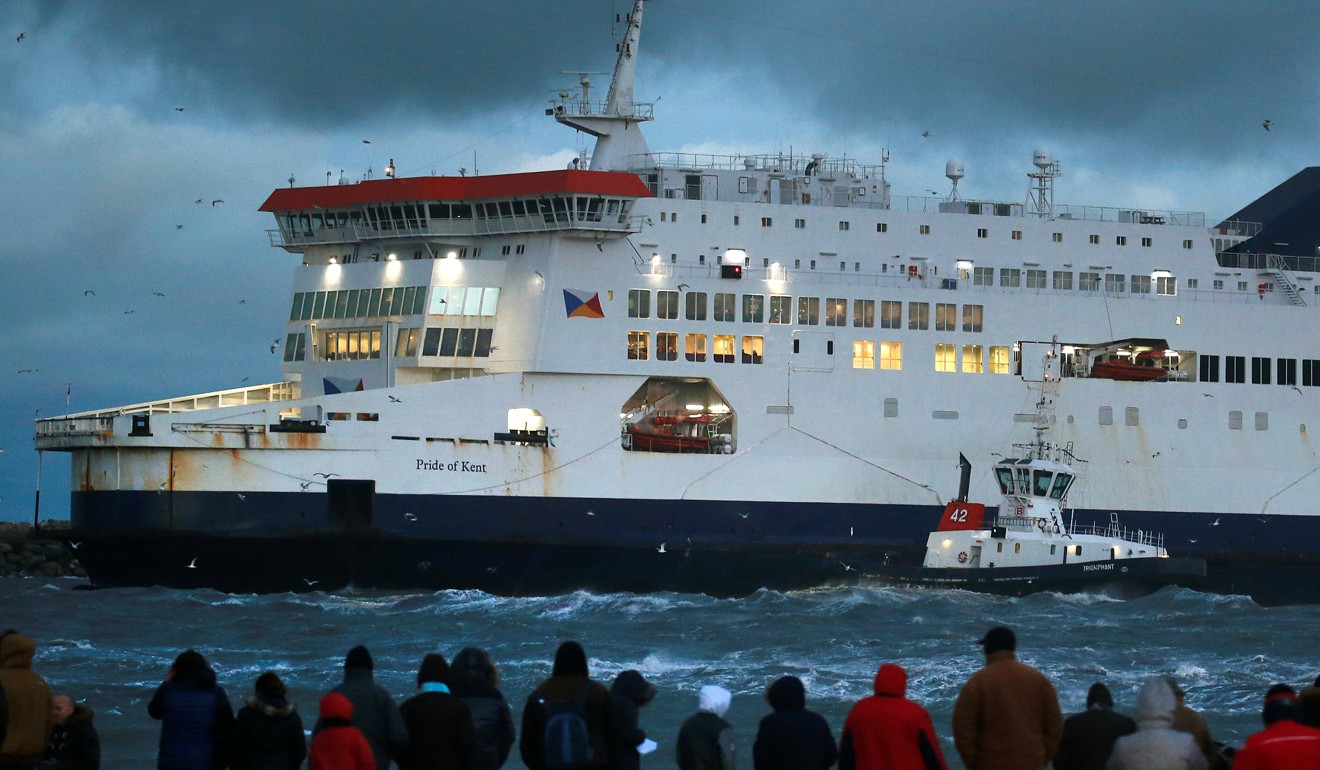 Bystanders look on as a tugboat manoeuvres the P&O ferry Pride of Kent after it ran aground during bad weather in the port of Calais. Photo: Reuters