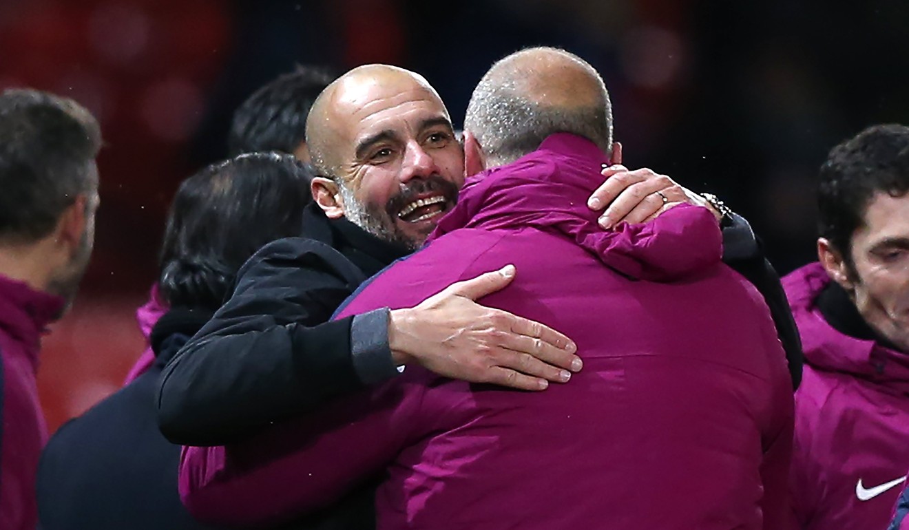 Pep Guardiola celebrates with his coaching staff after beating Manchester United. Photo: EPA