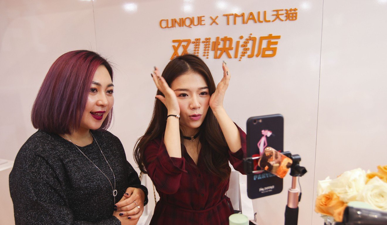 Two sales girls conduct a live online streaming of a cosmetic product promotion as part of the Tmall Singles' Day shopping festival in Shanghai on November 11, 2017. Photo: Simon Song