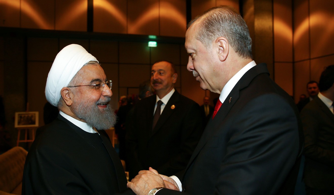 Turkish President Recep Tayyip Erdogan welcomes Iranian President Hassan Rowhani at the OIC. Photo: AFP
