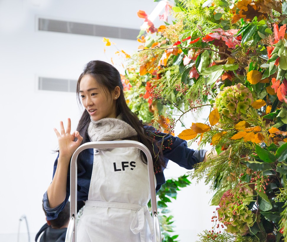 Hongkonger Kacey Chan works on a floral arch at the London Flower School in November. Picture: Marcelo Deguchi