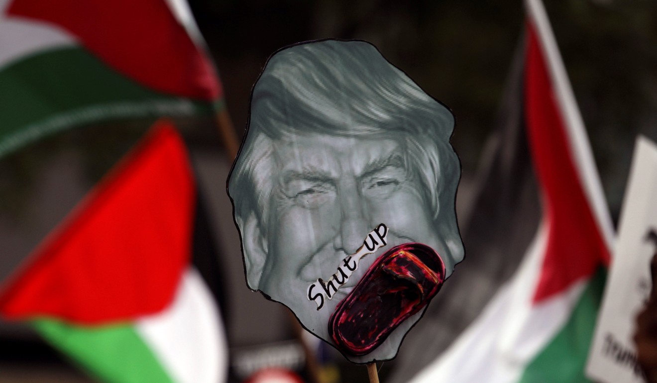 Pro-Palestine protesters hold a placard of US President Donald Trump as they march towards the US Embassy in Kuala Lumpur, Malays. Photo: Reuters