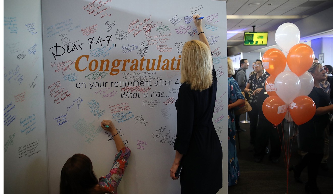 Passengers sign a card before boarding United Airlines flight 747 for its final flight from San Francisco International Airport to Honolulu, Hawaii on November 7, 2017 in San Francisco, California. United Airlines is retiring its fleet of Boeing 747 aircraft. File photo: AFP