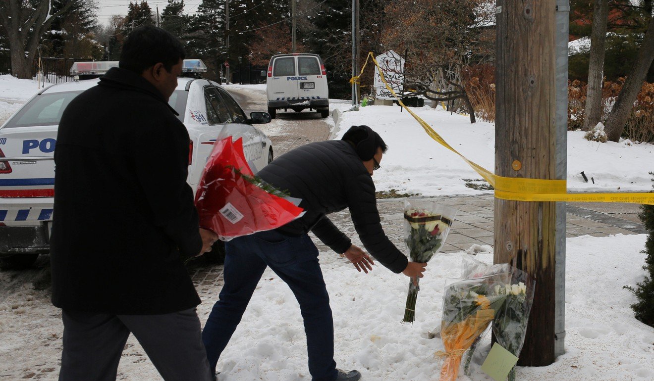 Mourners place flowers outside the home of billionaire founder of Canadian pharmaceutical firm Apotex, Barry Sherman and his wife Honey, who were found dead under circumstances that police described as suspicious, in Toronto. Photo: Reuters