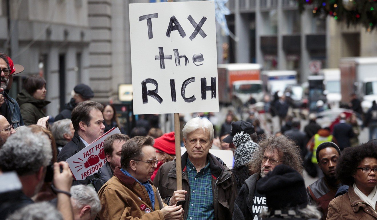 People gather to protest new tax legislation being passed by the United States Congress in front of the New York Stock Exchange. Photo: EPA-EFE