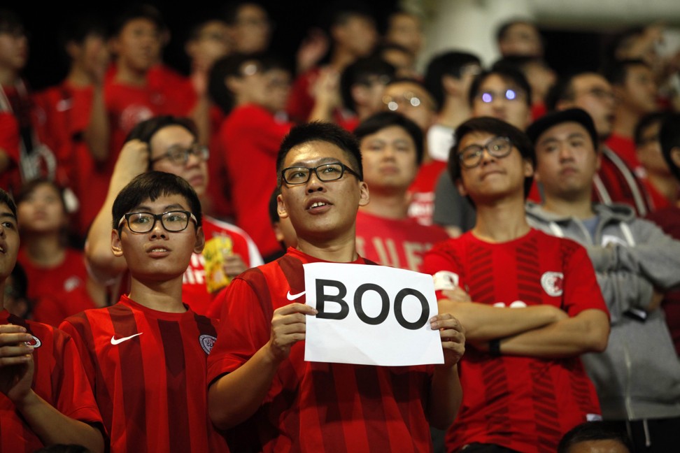 A Hong Kong fan holds up a sign that reads 
