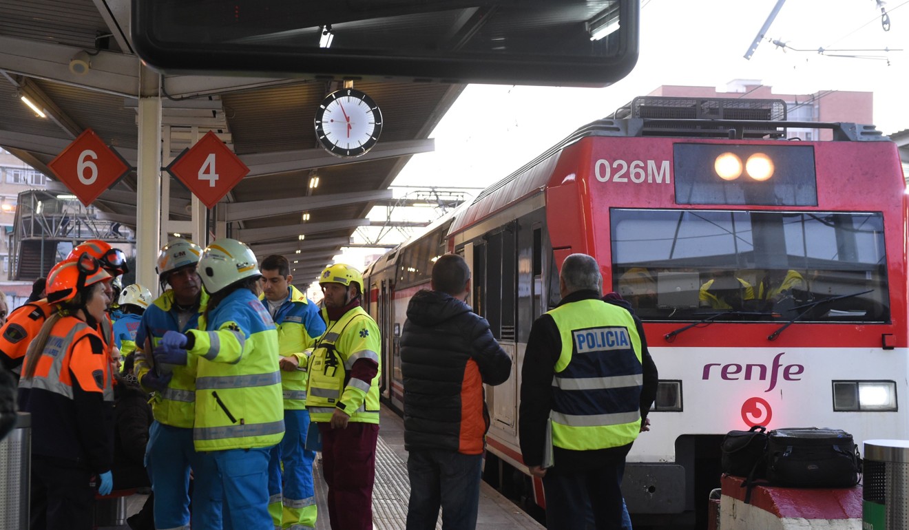 Spanish emergency service personnel treat an injured person after a train crashed into the buffer stop at the train station of Alcala de Henares, Madrid, Spain. Photo: EPA-EFE