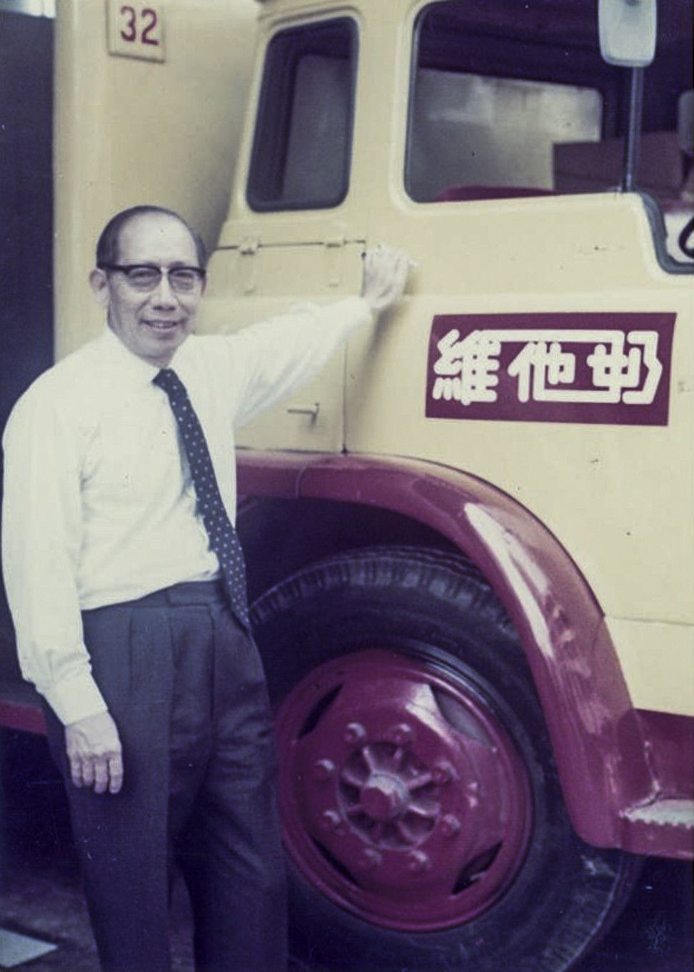 Lo Kwee-seong of Vitasoy stands next to a Vitasoy truck in this undated photograph.