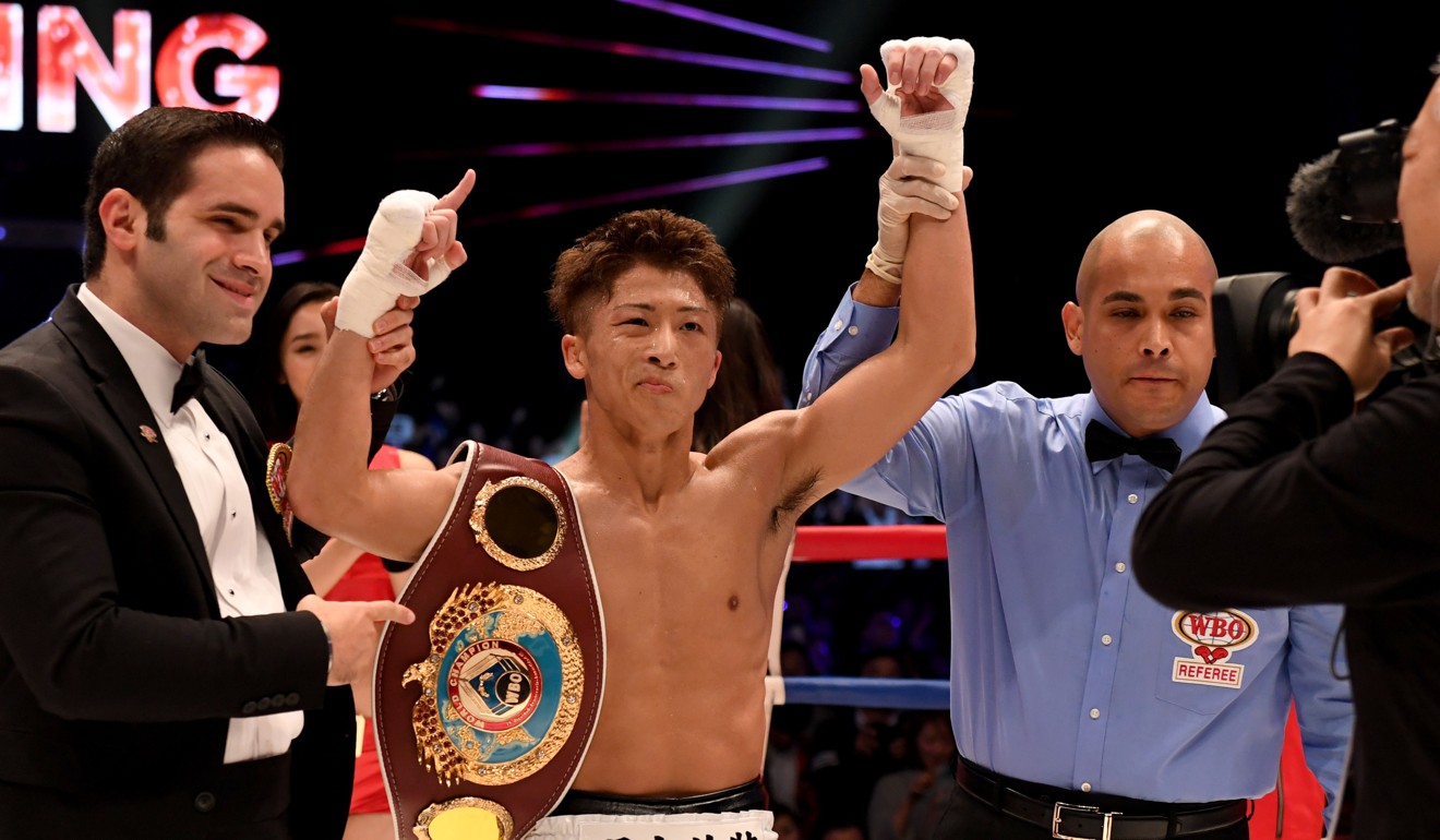 Japan’s Naoya Inoue raises his arms in triumph after retaining his WBO super flyweight title in Yokohama on Saturday. Photo: AFP