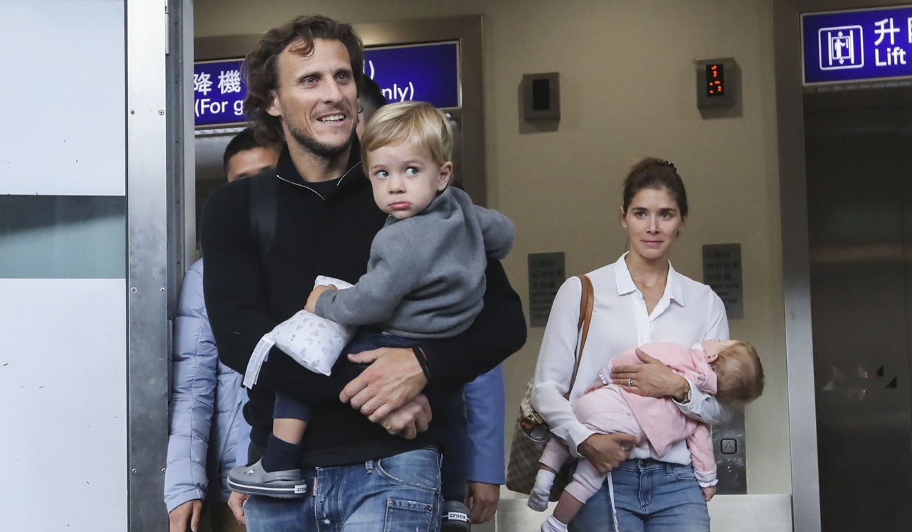 Diego Forlan arrives with his wife, Paz Cardoso, and kids at Chek Lap Kok.