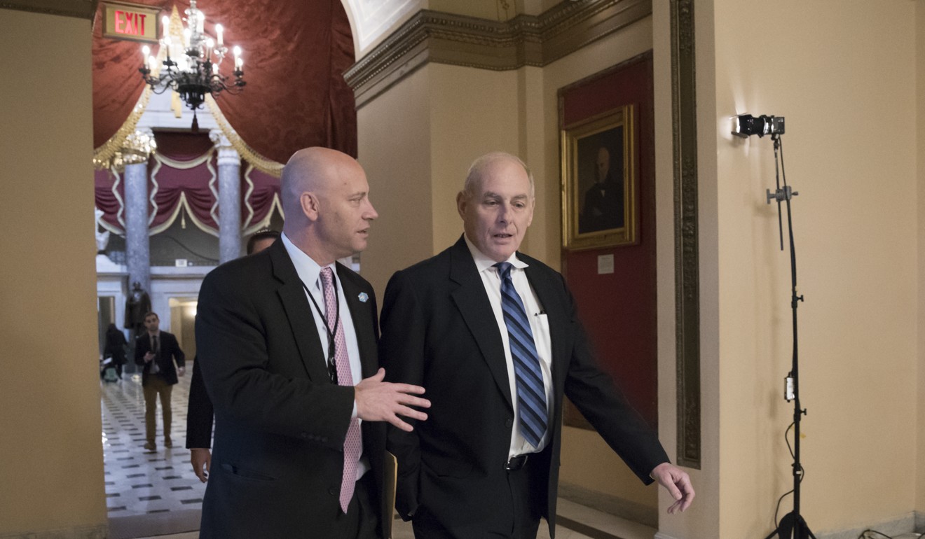 White House Chief of Staff John Kelly, centre, is escorted to the House chamber by Marc Short, left, the White House legislative liaison, just before the vote to reauthorise the Foreign Intelligence Surveillance Act (FISA) in Washington, on Thursday. Photo: AP