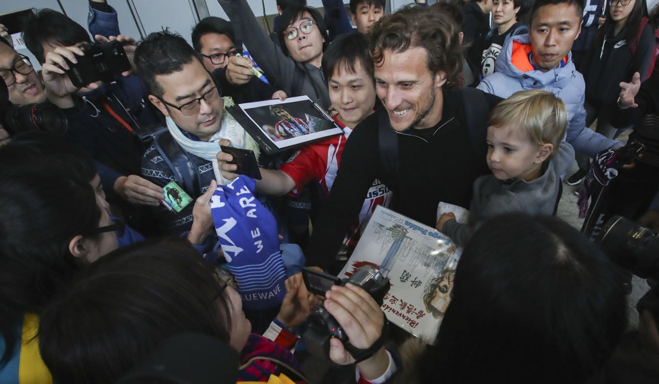 Kitchee’s new Uruguayan striker Forlan is greeted at Hong Kong International Airport on Thursday. Photo: Edward Wong