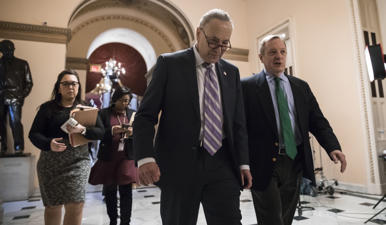 Senate Minority Leader Chuck Schumer walks with Senator Dick Durbi on Thursday as lawmakers continue negotiating on immigration at the Capitol in Washington. Photo: AP