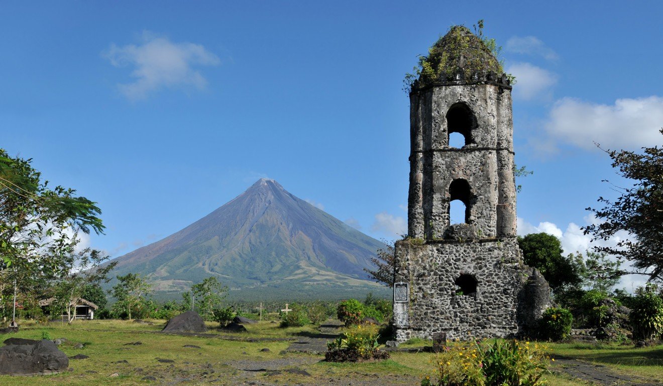 The belfry of a Cagsawa church juts out of the ground in a reminder of Mayon’s deadly fury that has become a tourist attraction. Photo: Handout