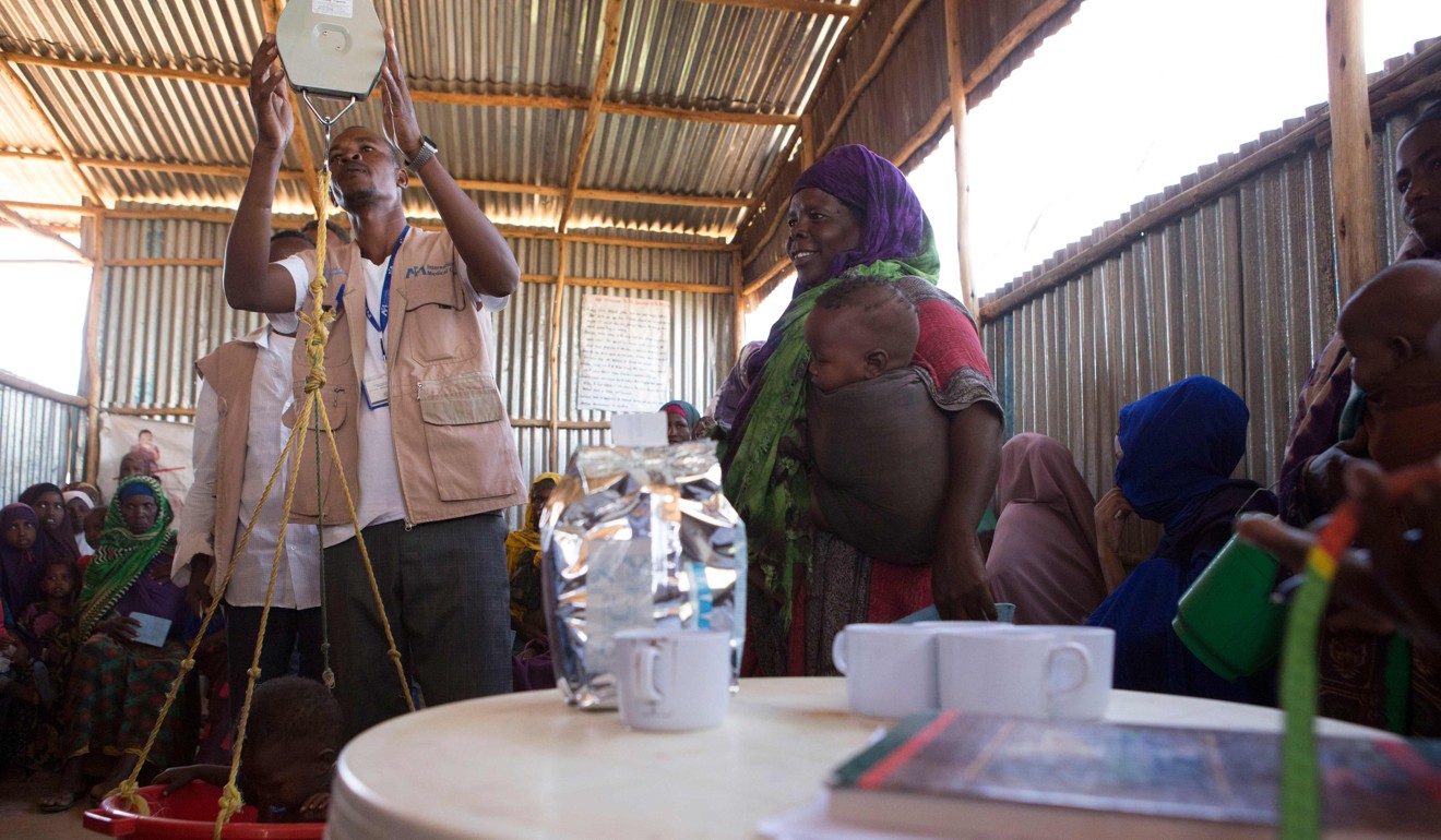 A woman has her child weighed and tested for malnutrition in a centre run by International Medical Corps (IMC) at Mekladida Refugee Camp in the Somali region of Ethiopia on December 19, 2017. Some 23 camps were destroyed by security forces late in 2017 and thousands are forced to live rough in the outskirts of the capital, Mogadishu. Photo: AFP