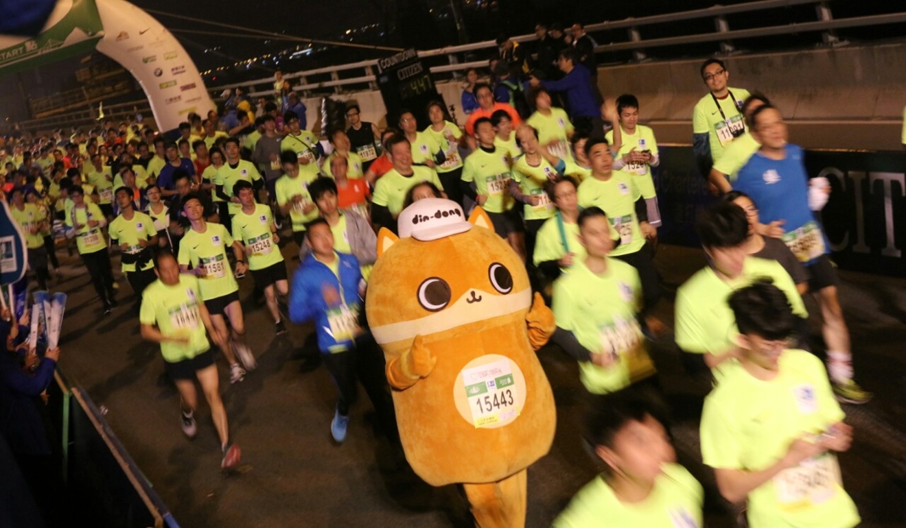 Runners, including Din-Dong, at the start of the Hong Kong Marathon in Tsim Sha Tsui. Photo: Felix Wong