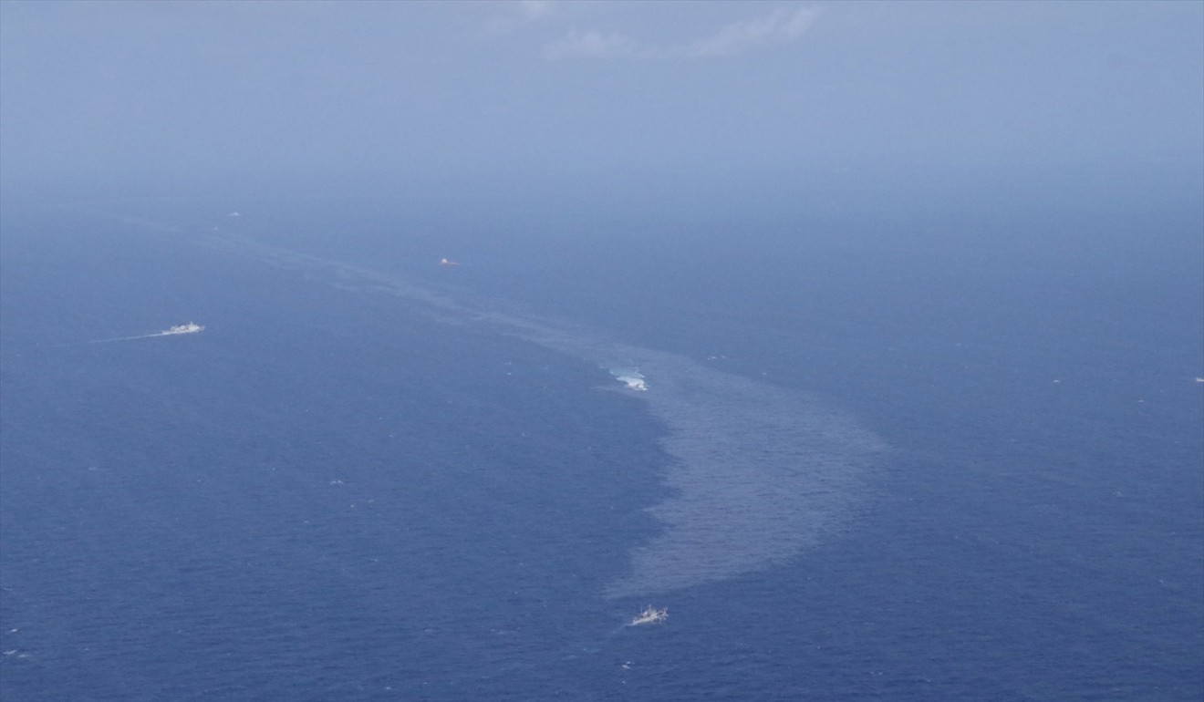 The slick is expanding in a spawning ground for species like the swordtip squid, according to Greenpeace. Photo: Reuters