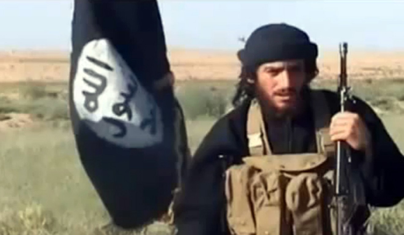 Abu Mohammad al-Adnani al-Shami of Islamic State speaks next to an Islamist flag on a YouTube video in 2016. Adnani was later killed in Aleppo. Photo: AFP/YouTube