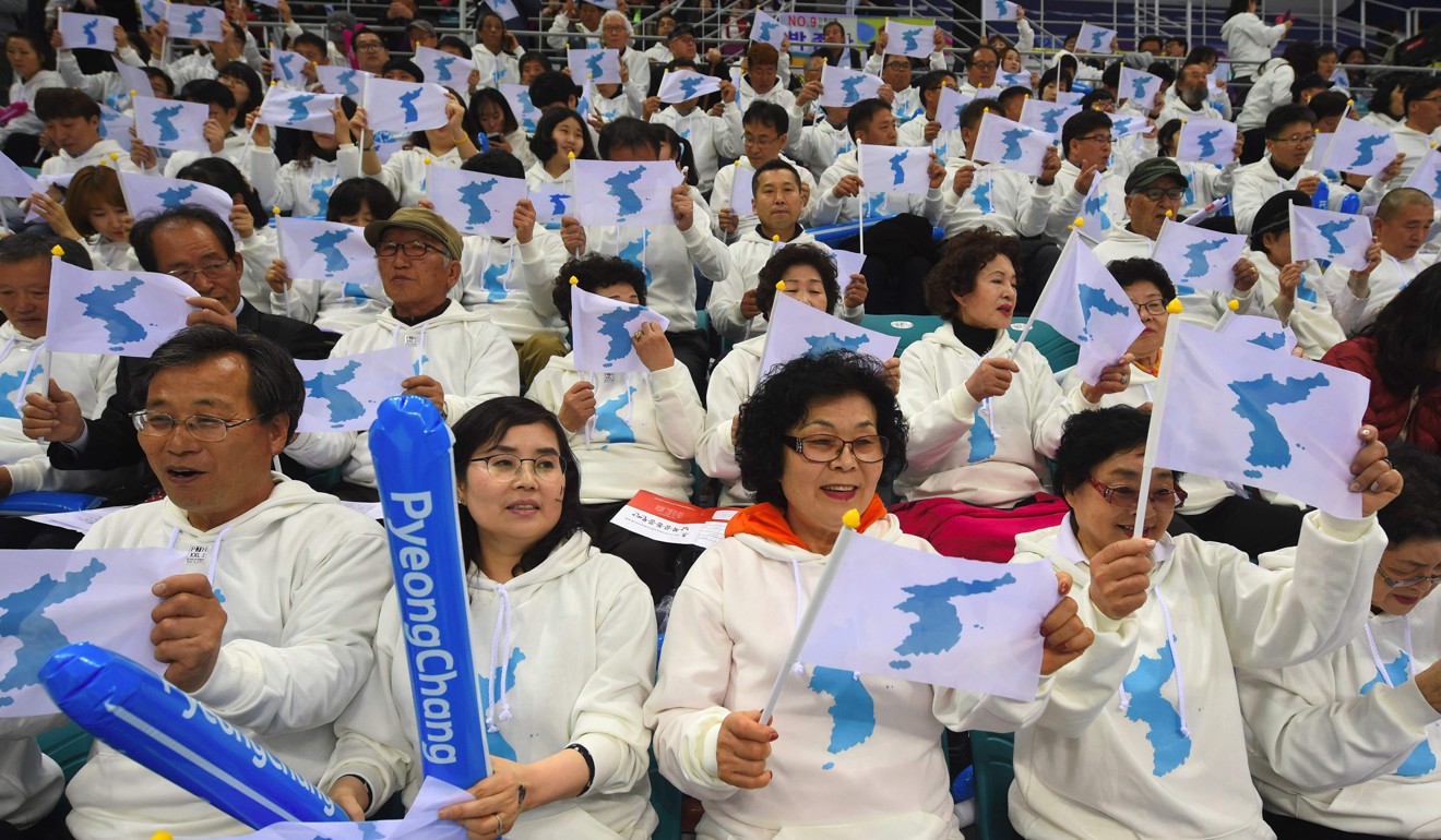 South Korean fans wave so-called unification flags as they cheer for North Korean players during the IIHF women's world ice hockey championships in Gangneung, South Korea, last April. The two Koreas marched together under the unification flag, which was introduced in 1991, at several sporting events between 2000 and 2006, during a relative high point in inter-Korean relations. Photo: AFP
