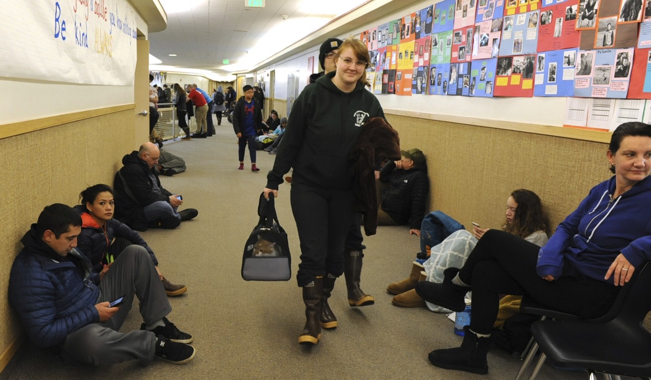 Tsunami evacuees line the hallway at Sitka High School in Alaska on Tuesday. Photo: AP