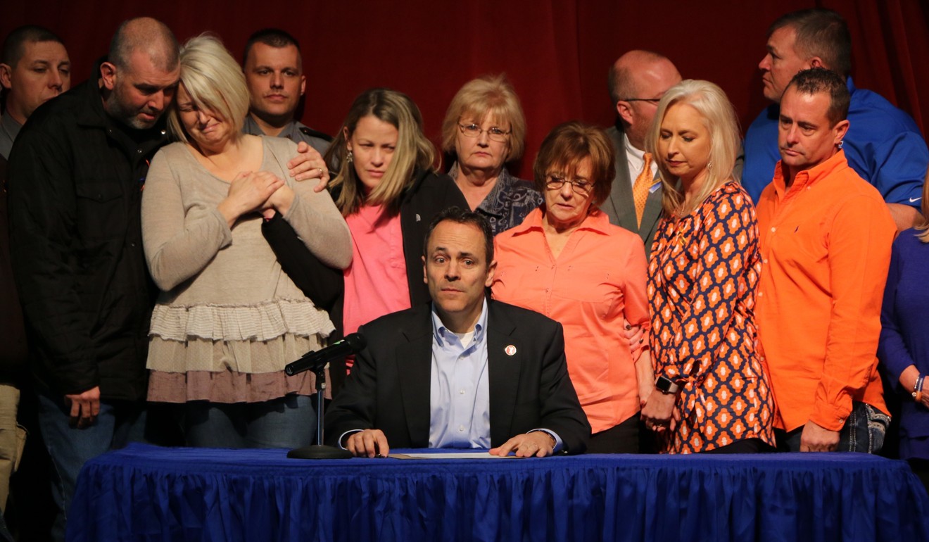 The parents of the deceased 15 year old Bailey Holt, left, stand in tears as Kentucky Gov. Matt Bevin signs a proclamation for a Day of Prayer on Friday in Benton, Kentucky. Bevin has vowed not to sign gun control legislation. Photo: AP