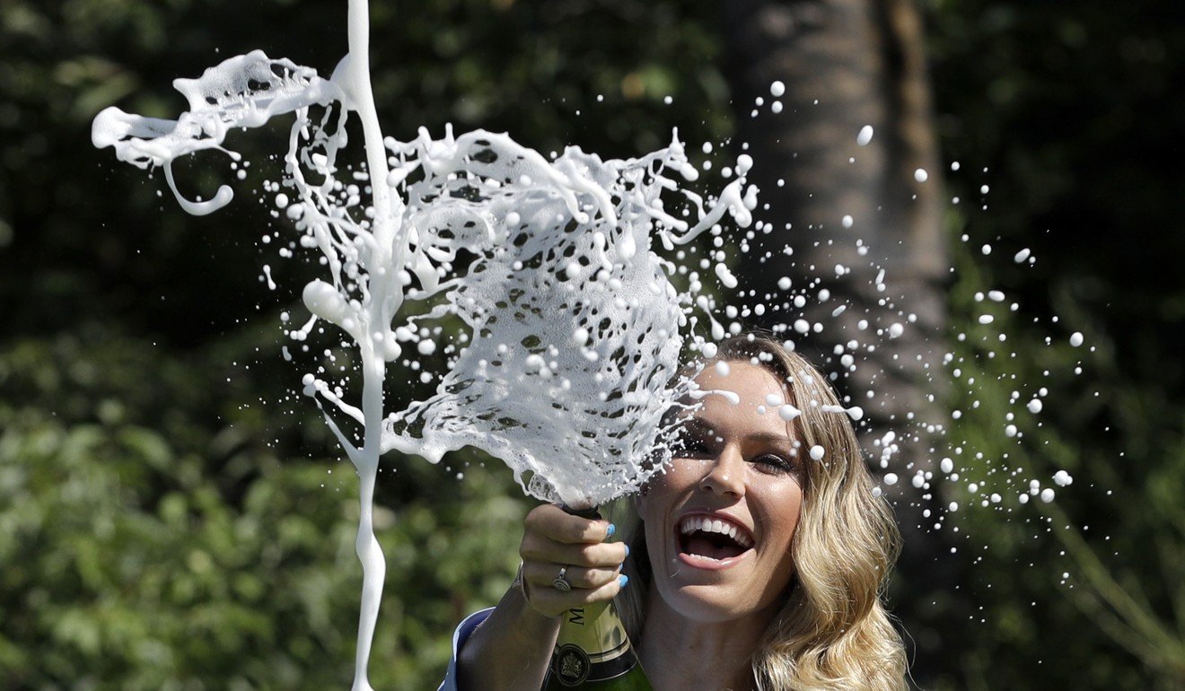Caroline Wozniacki sprays champagne during a photo shoot in the Royal Botanical Gardens in Melbourne. Photo: AP