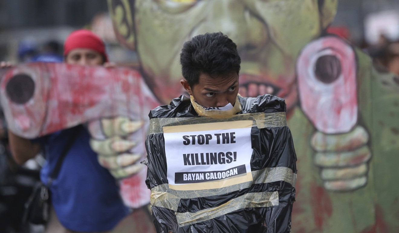 A protester wrapped in a plastic bag to re-enact the alleged extrajudicial killings by police. Photo: AP