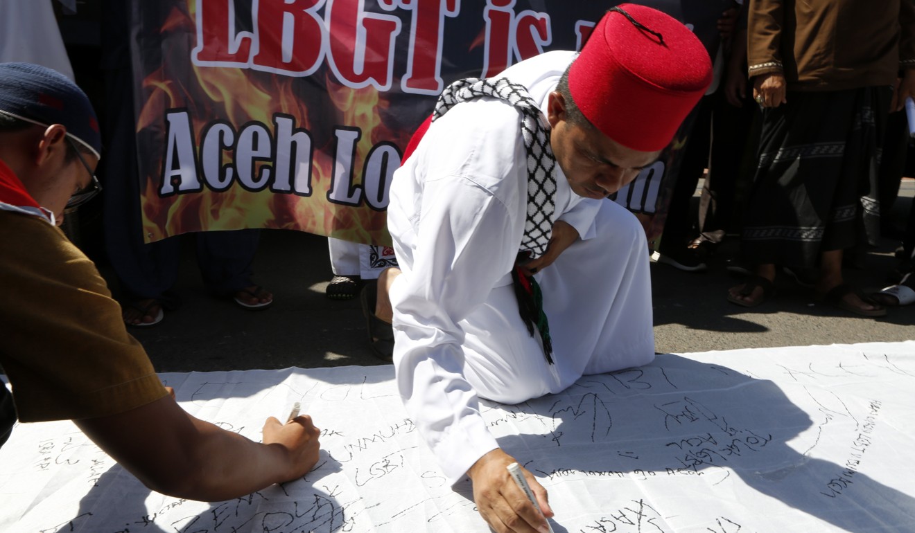 Activists sign a petition during an anti-LGBT rally in Banda Aceh, Indonesia. Photo: EPA