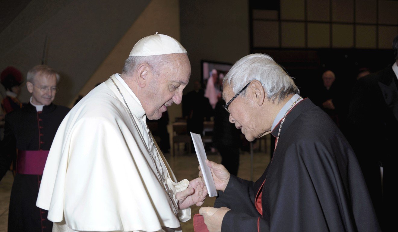 Retired archbishop of Hong Kong Cardinal Joseph Zen hands a letter to Pope Francis at the end of his weekly general audience in Paul VI, at the Vatican. Photo: AP Photo