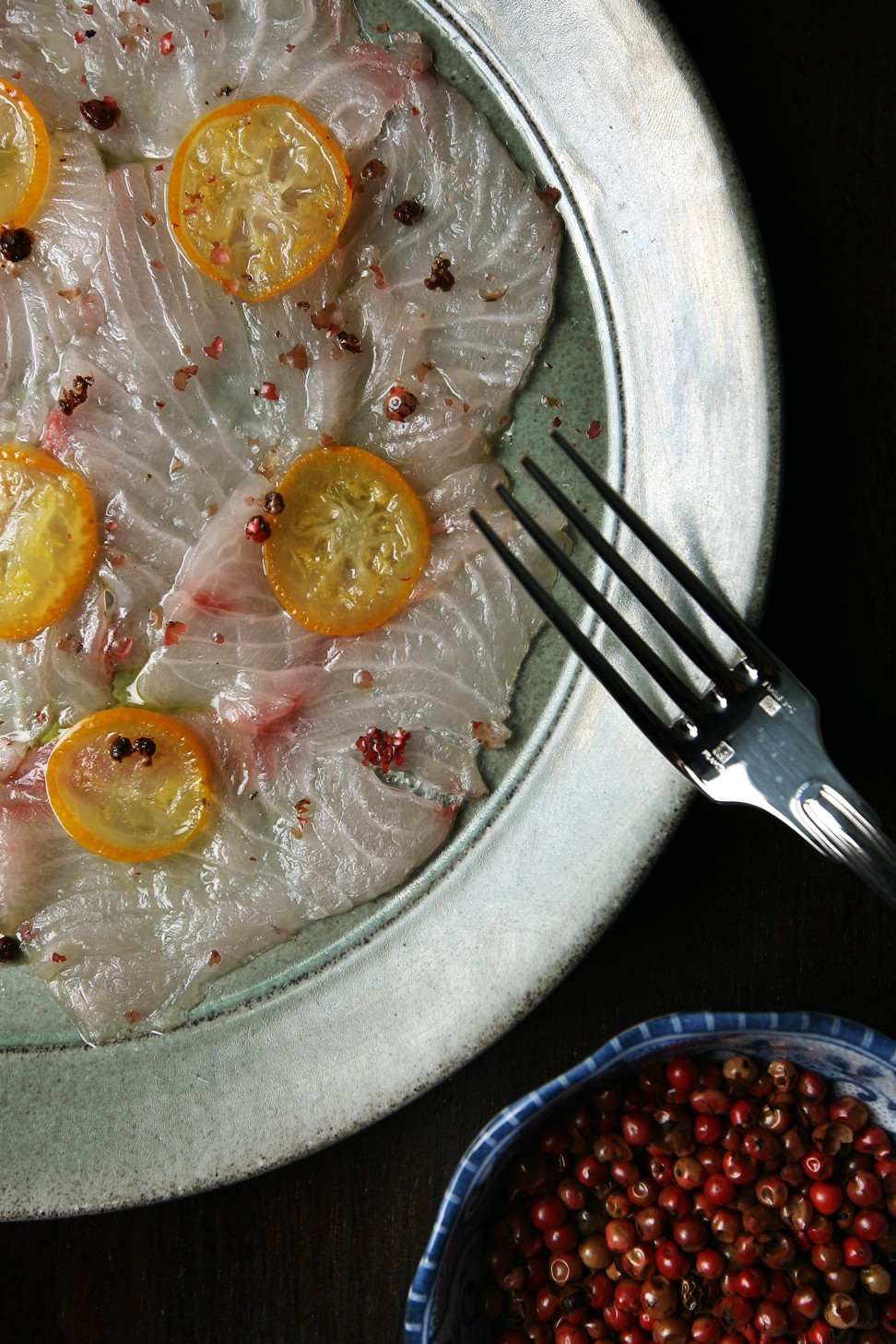 Hamachi carpaccio with kumquat oil and pink peppercorns. Photo: Jonathan Wong