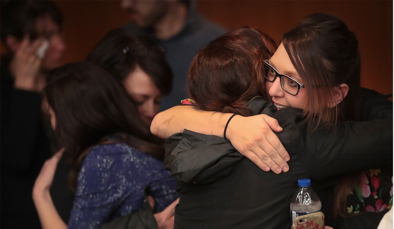 Victims and their family members embrace following the sentencing hearing for Larry Nassar in Eaton County Circuit Court on February 5, 2018 in Charlotte, Michigan. At the hearing, Nassar was sentenced to 40 to 125 years in prison. He is currently serving a 60-year sentence in federal prison for possession of child pornography. Last month a judge in Ingham County, Michigan sentenced Nassar to 40 to 175 years in prison after he plead guilty to sexually assaulting seven girls. Photo: Getty Images/AFP
