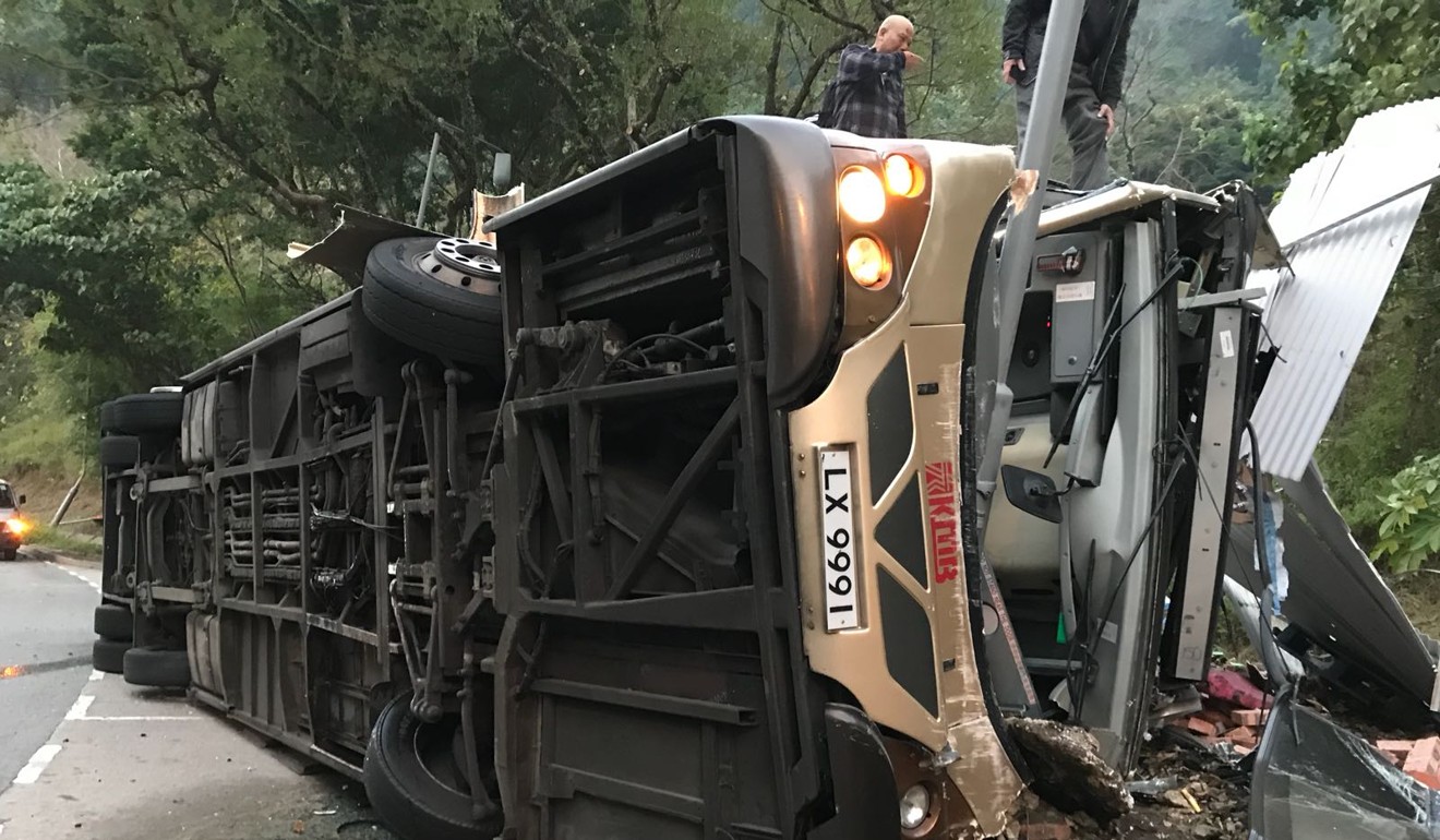 The bus had come to a stop after crashing into a lamp post while on its side. Photo: Facebook