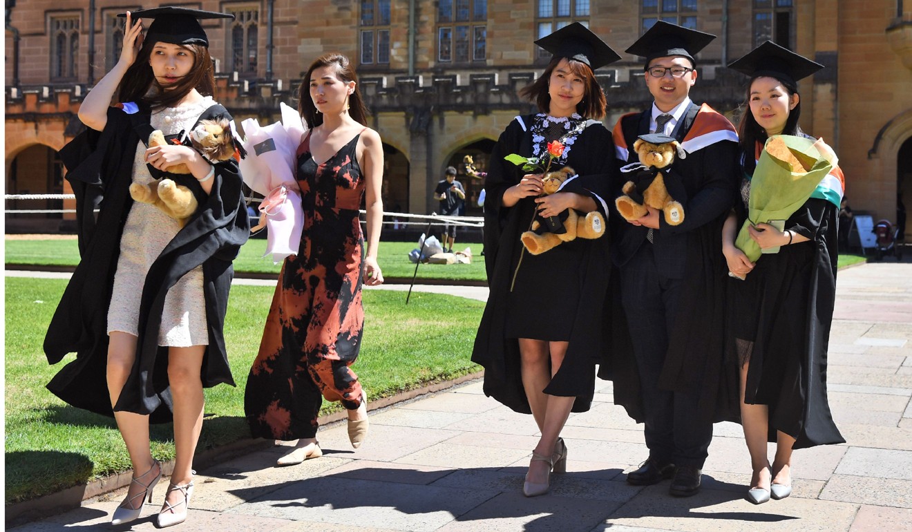 File photo of students from China posing for family photos after graduating from Sydney University. Photo: AFP