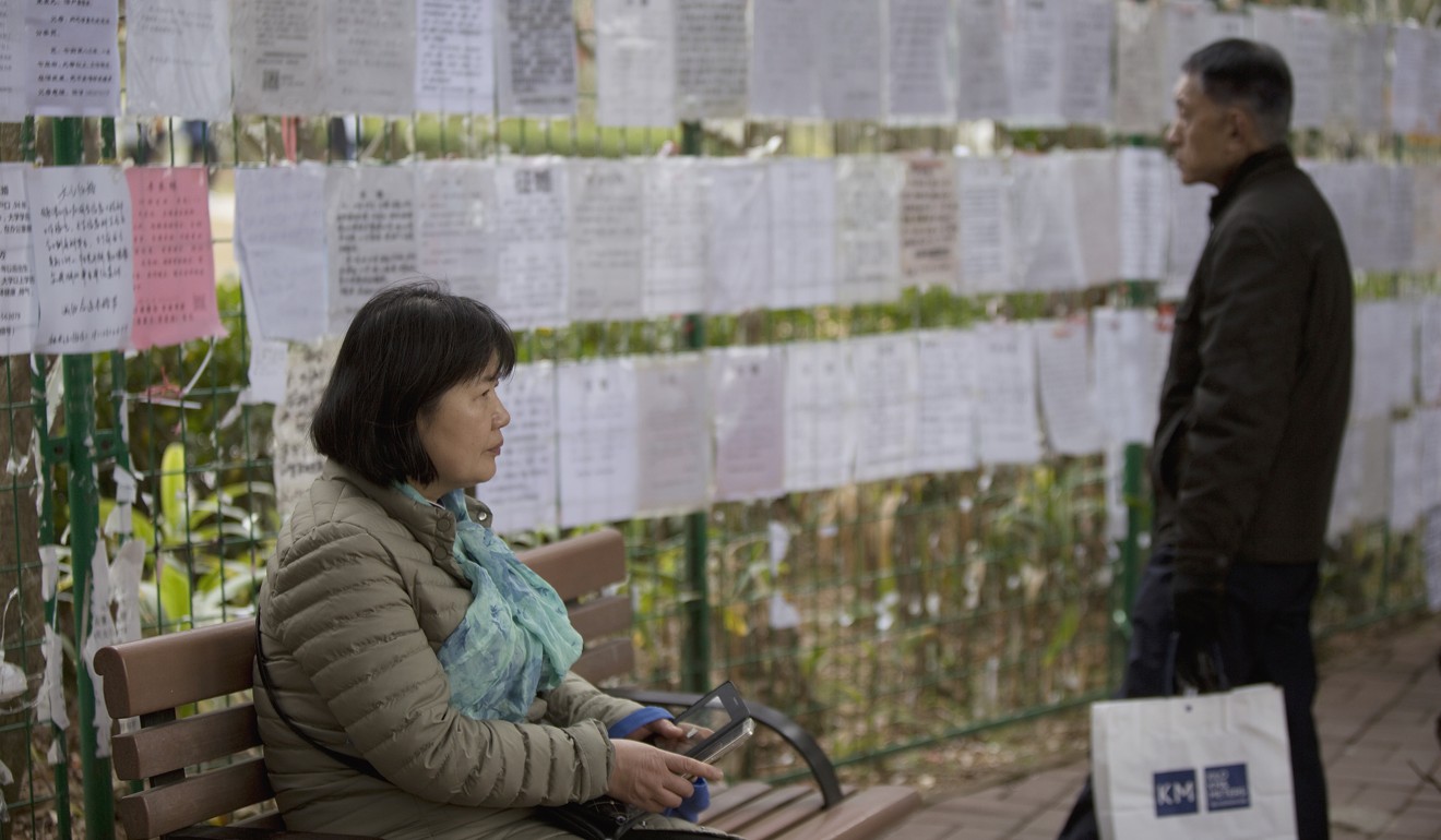 Local people check out the profiles of single men and women hung up in Shenzhen’s Lianhuashan Park. Photo: Xiaomei Chen