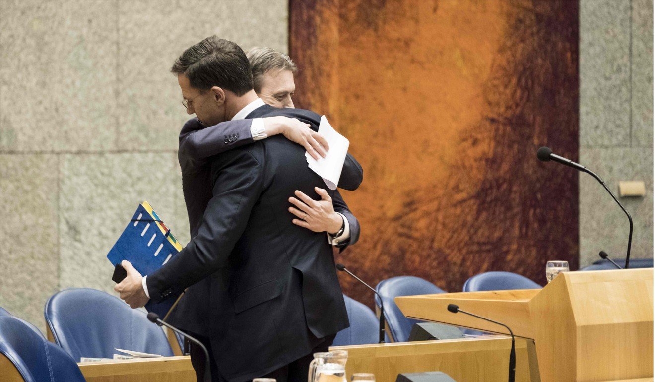 Zijlstra hugs Prime Minister Mark Rutte after announcing his resignation in the Dutch parliament on Tuesday. Photo: ANP via AFP