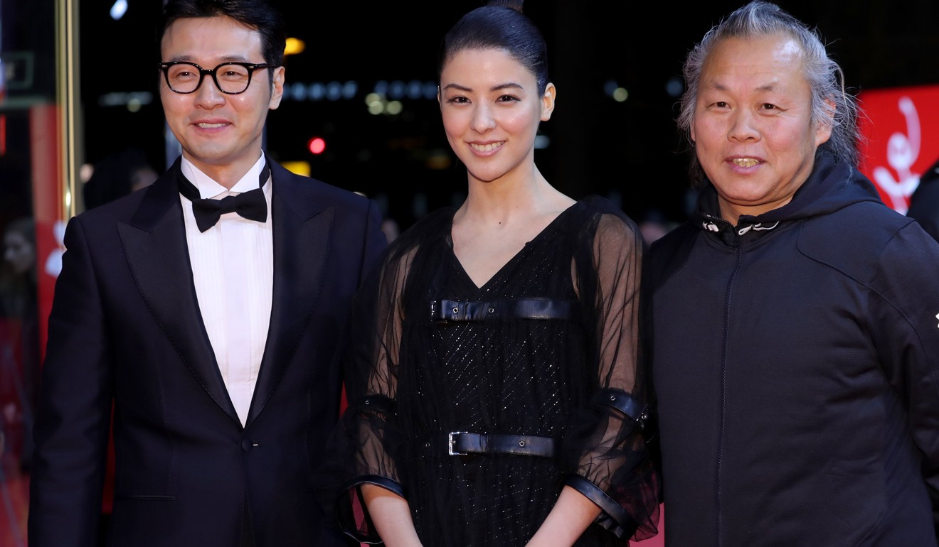 South Korean actor Lee Sung-jae, Japanese actress Mina Fujii and South Korean director Kim Ki-duk on the red carpet for Human, Space, Time and Human at the Berlin International Film Festival on February 17, 2018. Photo: EPA